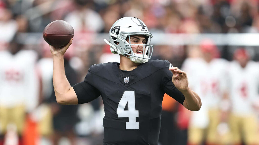 Aidan O'Connell Las Vegas Raiders quarterback focused throwing football during intense game action Wallpaper
