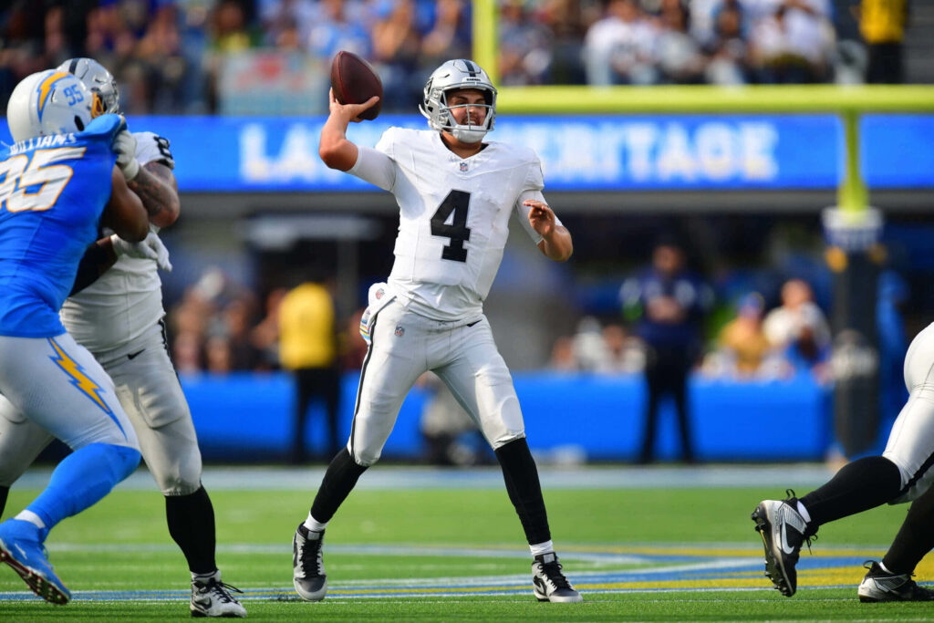 Aidan O'Connell throwing football pass during intense quarterback action game wallpaper background