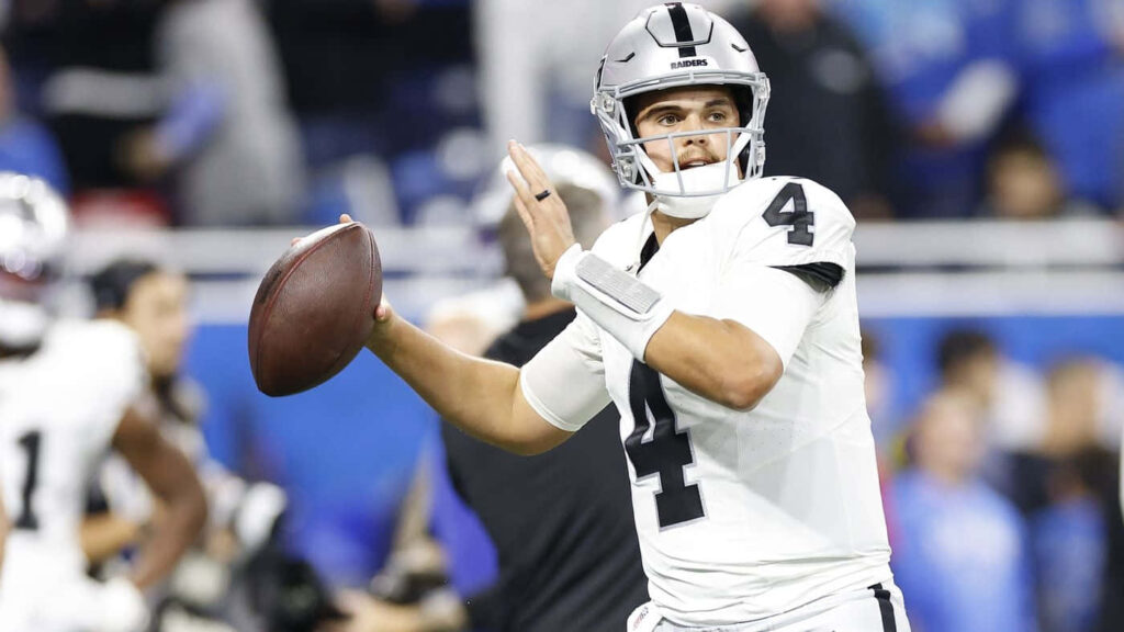 Aidan O'Connell Raiders quarterback focused preparing to throw football pass on game field wallpaper