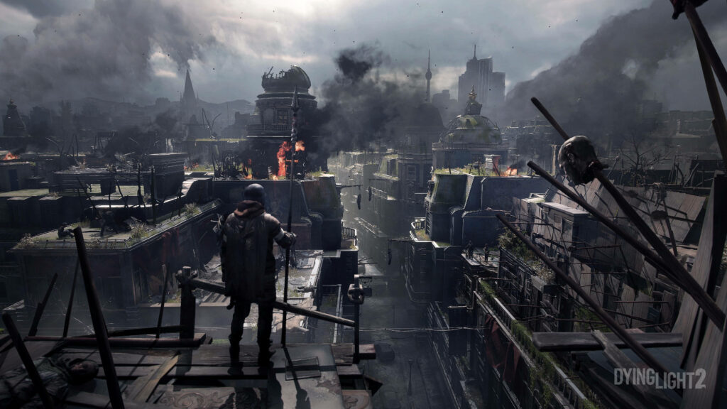 Aiden Caldwell on crumbling rooftop overlooking smoky ruined cityscape in post-apocalyptic Dying Light 2 Wallpaper