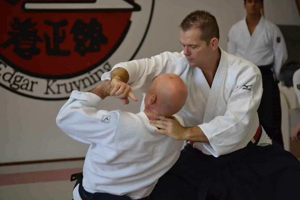 Traditional Aikido Technique: Sensei's Expert Demo in Focused Training Wallpaper