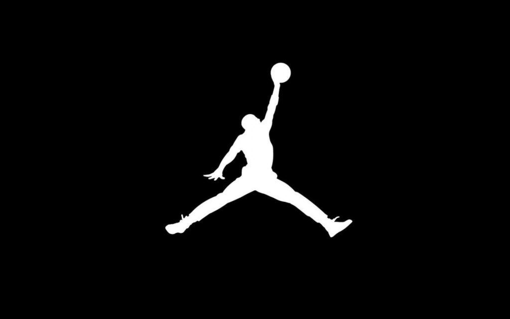 Striking Contrast: The Iconic Air Jordan Logo Standing Out on a Sleek Black Canvas Wallpaper