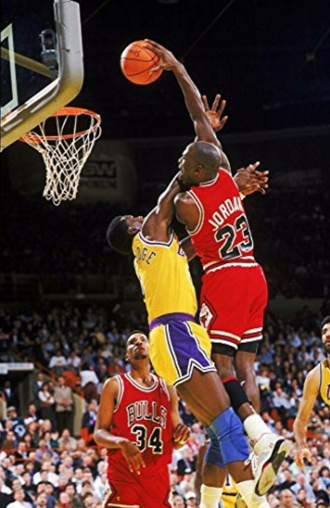 Michael Jordan's Explosive Shot in Basketball Arena Wallpaper