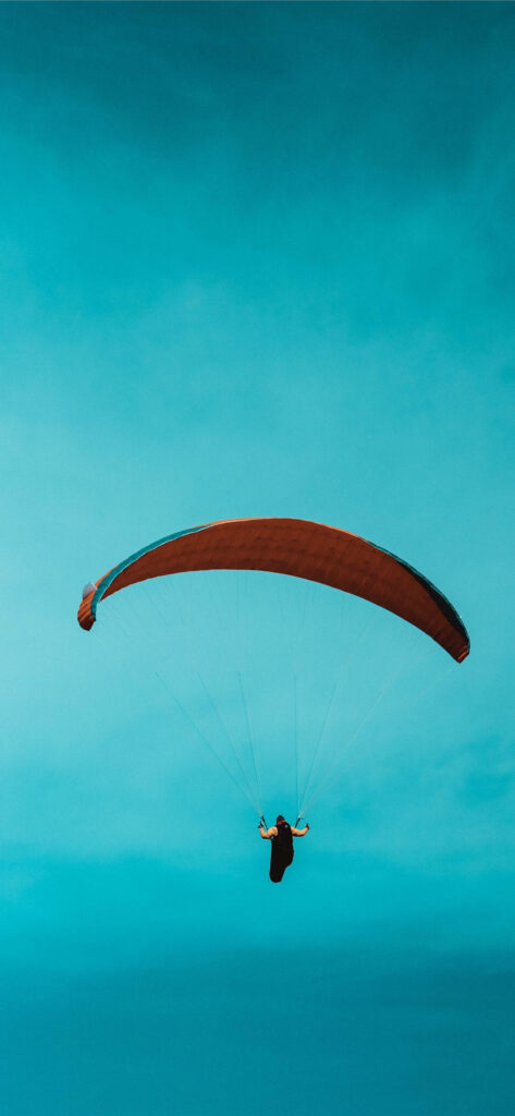 Taking Flight: Parasailing Adventure in a Pocket-Sized View Wallpaper