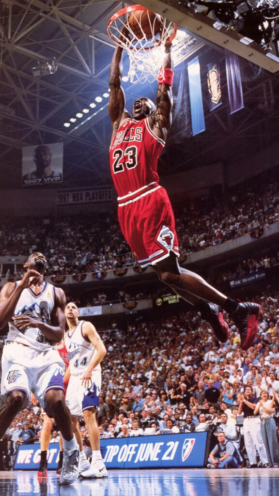 Airborne Majesty: Michael Jordan Dominating the Court in his Iconic Bulls Jersey Wallpaper