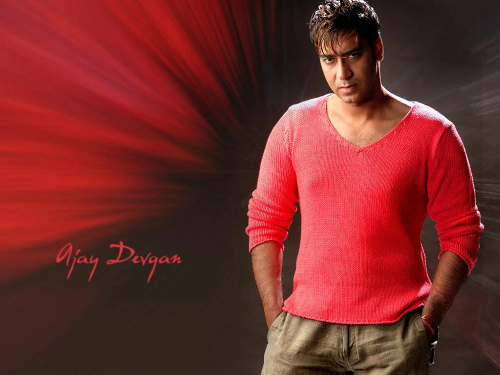 Ajay Devgn in red sweater with intense look on dynamic red aesthetic wallpaper background