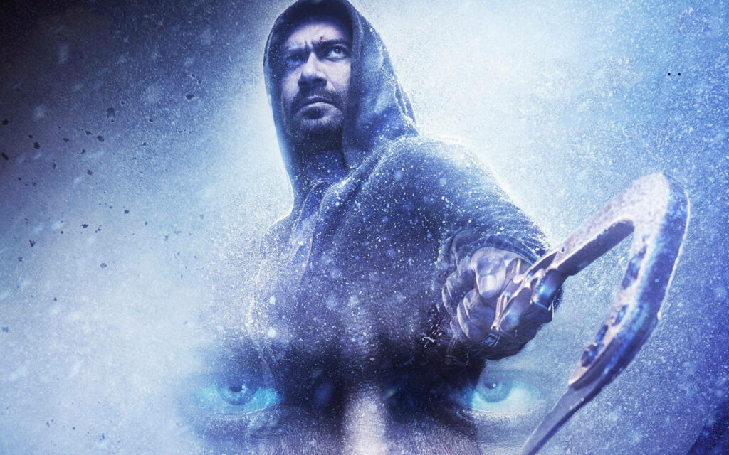 Ajay Devgn as Shivaay in snowy landscape holding ice axe intense blue tones dramatic scene Wallpaper