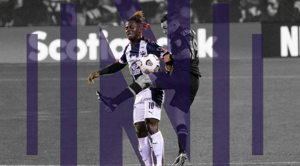 Aké Arnaud Loba skillfully controls soccer ball in intense match action wallpaper background