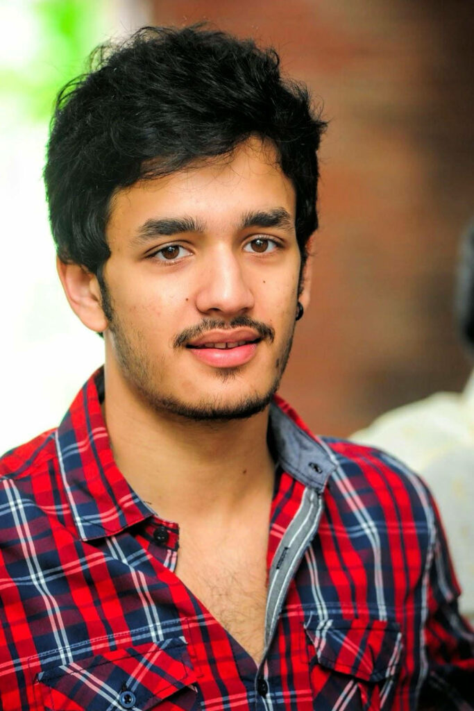 Akhil Akkineni in stylish unbuttoned checked shirt with casual relaxed backdrop wallpaper