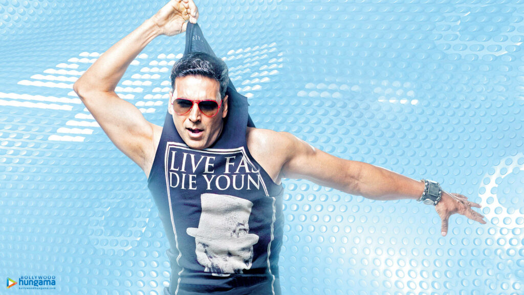 Akshay Kumar dynamic action pose energetic wallpaper blue background signature style