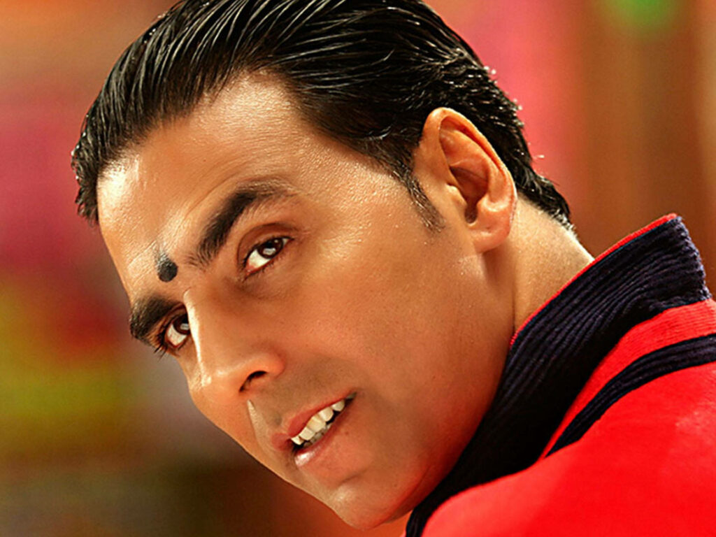 Bollywood actor Akshay Kumar close-up with charming expression vibrant colorful wallpaper background