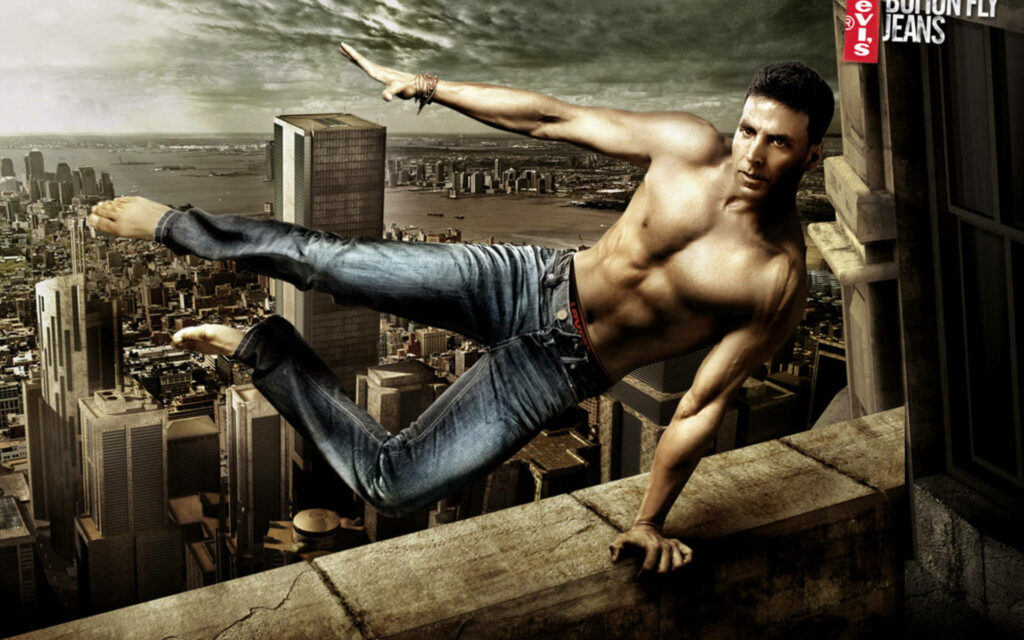Akshay Kumar in Levi's jeans dynamic pose dramatic cityscape background poster wallpaper