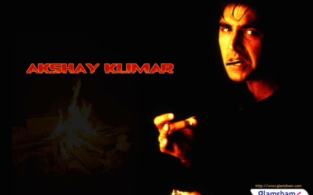 Akshay Kumar intense expression dramatic lighting burning campfire cinematic wallpaper background