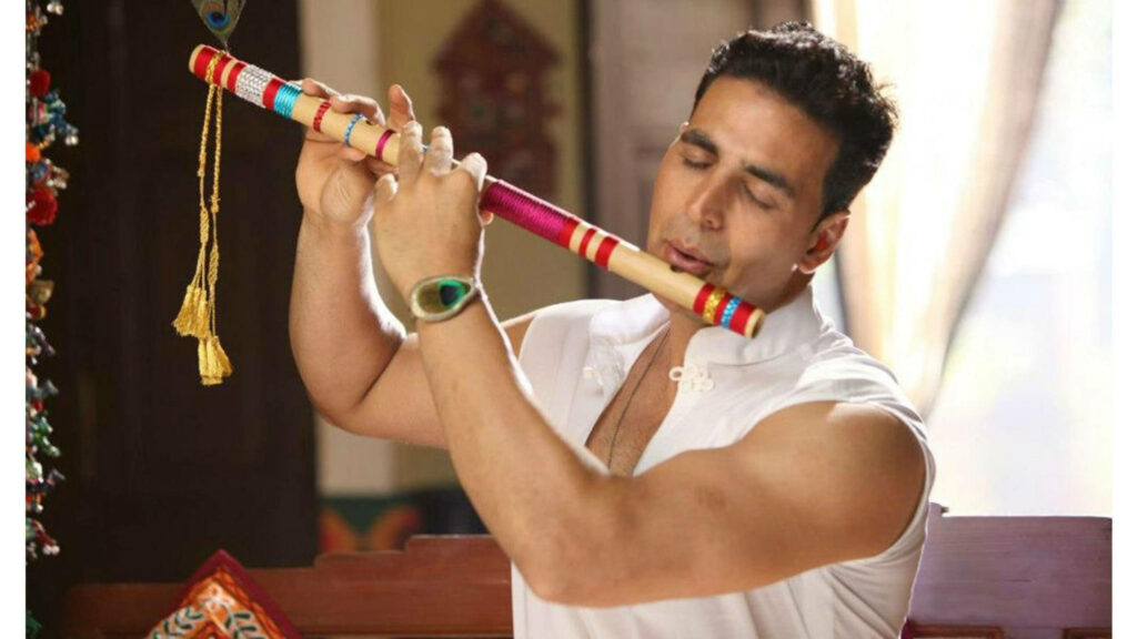 Akshay Kumar playing colorful flute creating calm artistic wallpaper background melody