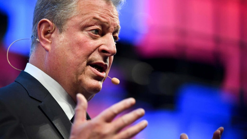 Al Gore speaking passionately with expressive gestures vibrant background American politician environmentalist Wallpaper