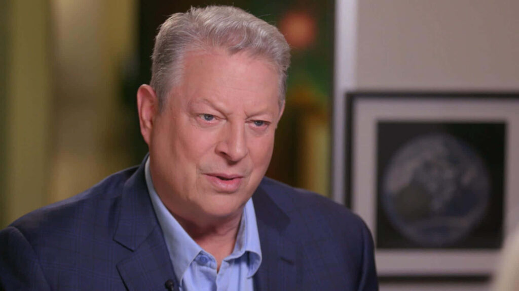 Al Gore in navy suit indoor professional setting environmentalist wallpaper background