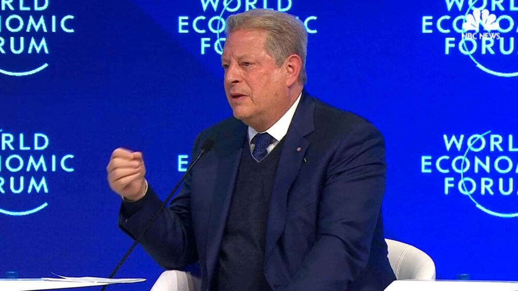 Al Gore speaking at World Economic Forum on global issues formal setting wallpaper background