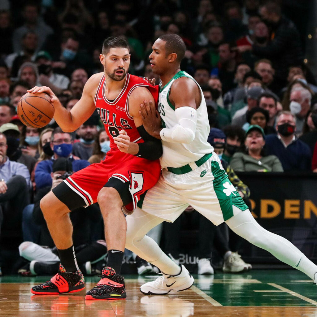 Al Horford fiercely defends opponent in intense basketball game showing strong defense skills Wallpaper