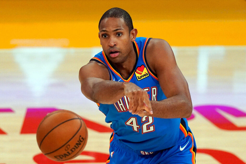 Al Horford focused making precise basketball pass showing leadership and determination wallpaper