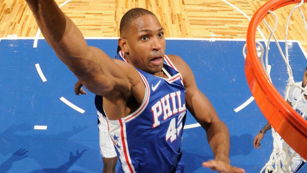 Al Horford mid-air slam dunk showcasing basketball athleticism and intense gameplay wallpaper