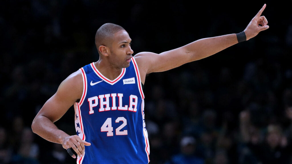 Al Horford in Philadelphia 76ers jersey confidently signaling on basketball court wallpaper
