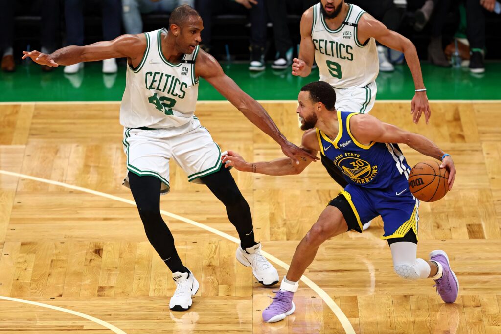 Al Horford Celtics defends Stephen Curry Warriors intense NBA game action wallpaper
