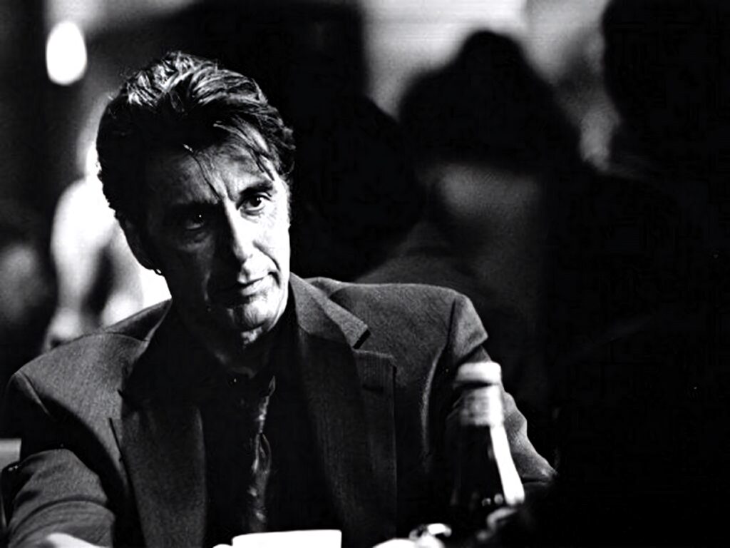 Black and white wallpaper of iconic Al Pacino face in classic contemplative moment background