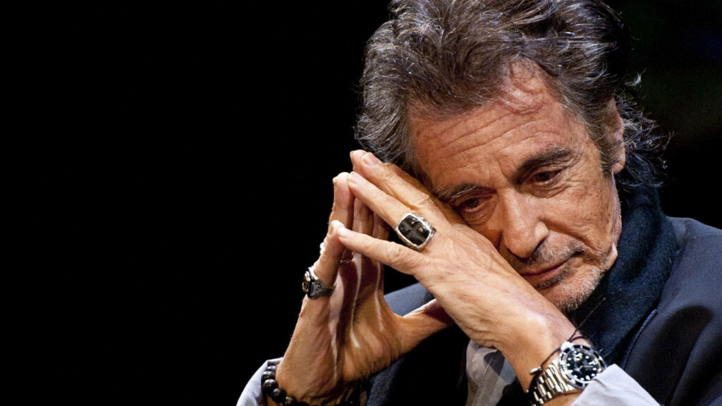 Close-up of Al Pacino showing signature rings and watch in thoughtful pose at Eventim Apollo Wallpaper
