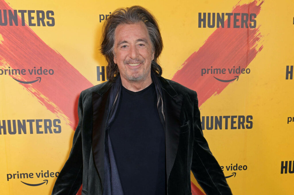 Al Pacino smiling in dark jacket casual shirt at yellow Hunters Prime Video backdrop wallpaper