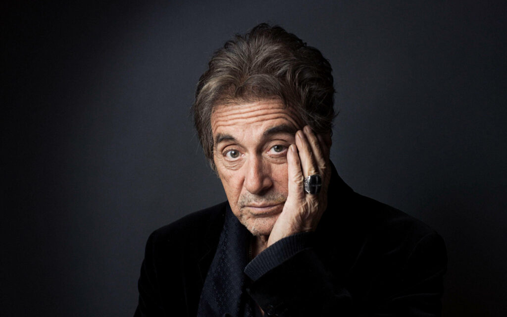 Al Pacino in thoughtful pose dark background meditative introspective wallpaper background