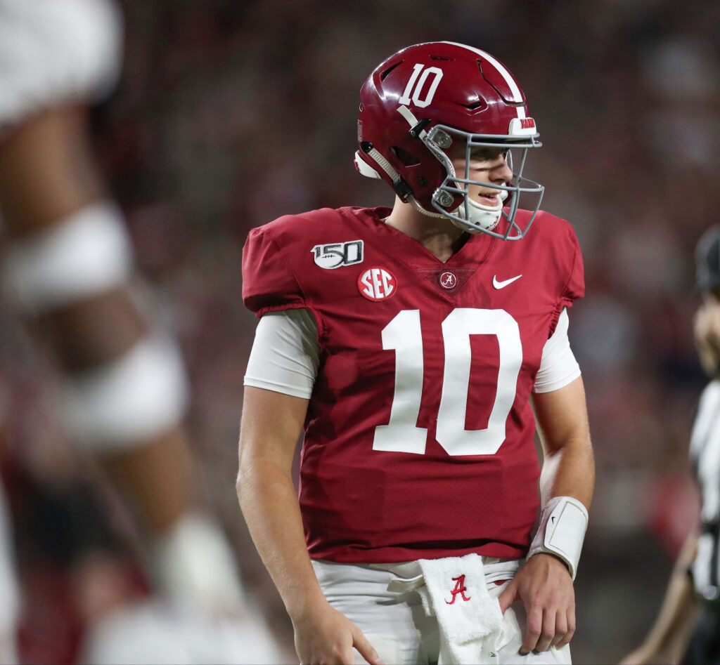 Alabama quarterback number 10 focused and ready on field intense game day football wallpaper