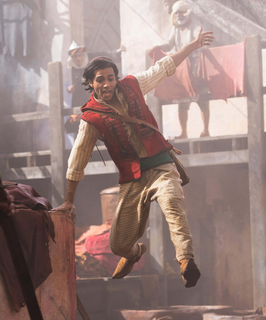 Aladdin's Adventurous Leap: Vibrant Marketplace Wallpaper Background
