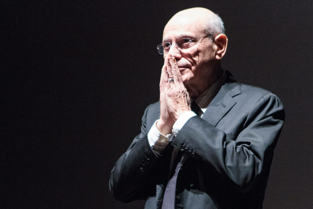 Alan Arkin in suit showcasing deep emotion and talent striking wallpaper background image