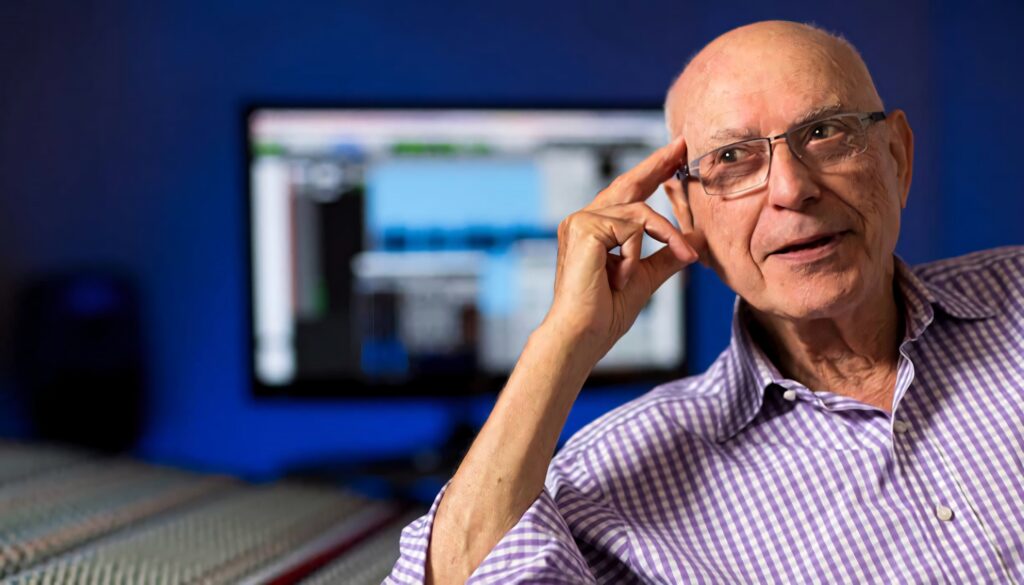 Alan Arkin thoughtful pose seated by studio equipment softly lit monitor The Kominsky Method wallpaper