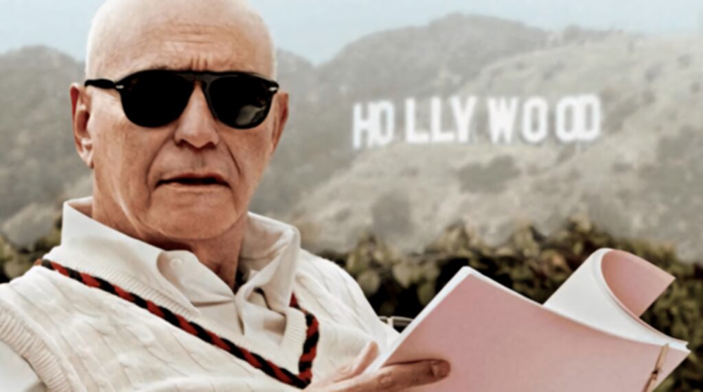 Alan Arkin as Lester Siegel wearing sunglasses holding script with blurred Hollywood sign background Wallpaper