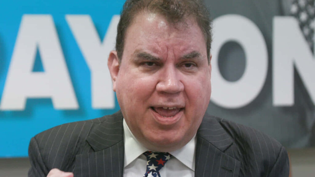 Alan Grayson speaking passionately with focused expression American politician wallpaper background