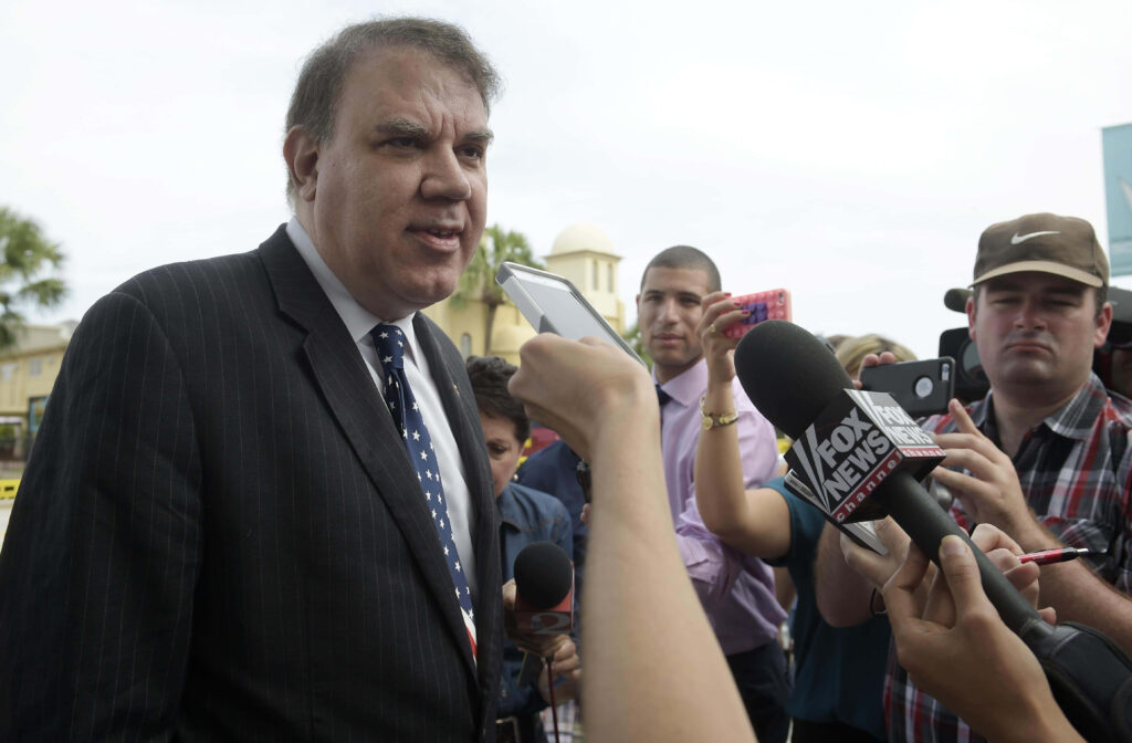 Alan Grayson American politician speaking to reporters outdoors during press interview with microphones Wallpaper