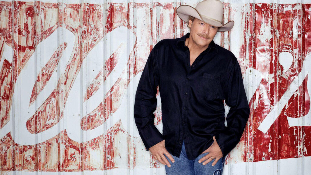 Alan Jackson in front of rustic chipped paint trailer wall classic country style wallpaper background