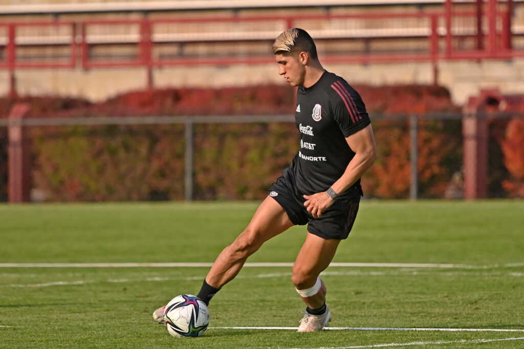 Alan Pulido training intensely on pitch showing focus and athleticism game preparation wallpaper