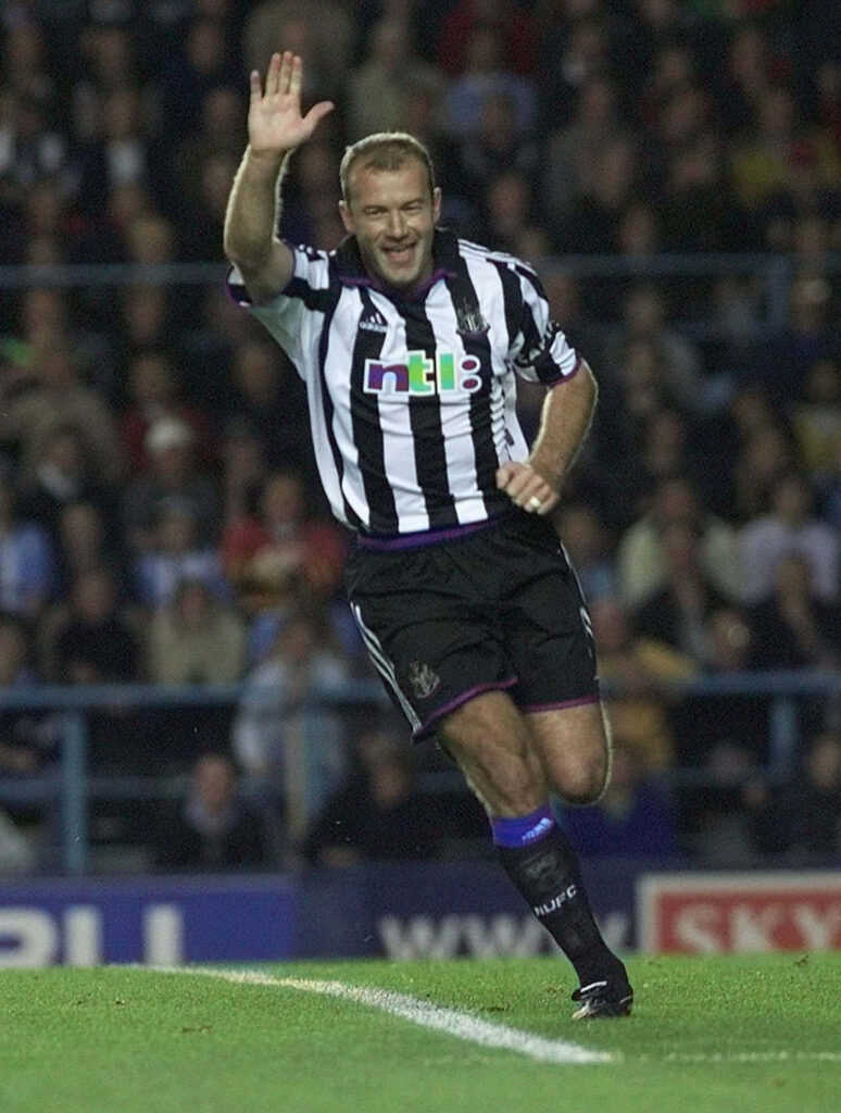 Alan Shearer celebrating iconic Newcastle United goal with raised arm in dynamic football wallpaper