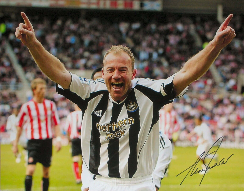 Alan Shearer celebrating Newcastle United goal energetic moment with autograph wallpaper background