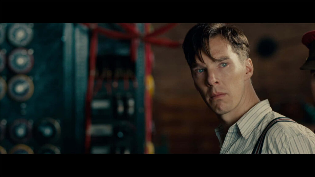 Alan Turing at codebreaking machine in The Imitation Game WWII cryptography scene wallpaper