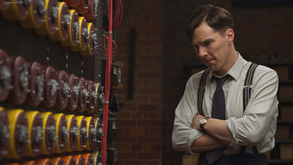 Alan Turing deep in thought beside code-breaking machine in The Imitation Game wallpaper background