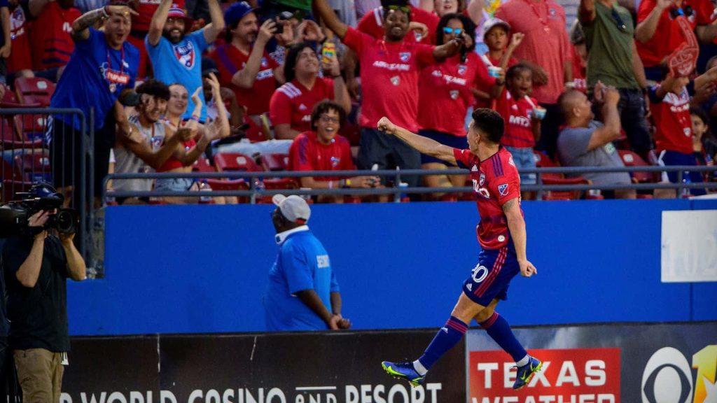 FC Dallas Alan Velasco celebrates with fans in red kit vibrant stadium high contrast soccer wallpaper