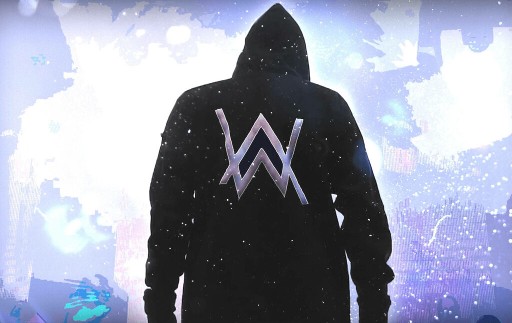 The Iconic Alan Walker: DJ Extraordinaire in His Signature Black Hoodie Against a Vibrant Backdrop Wallpaper