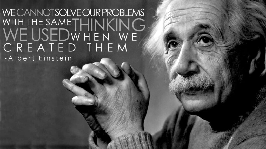 Black and white Albert Einstein wallpaper with famous quote on innovative problem solving background