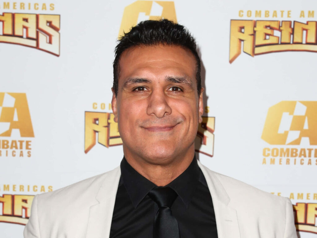 Alberto Del Rio in white suit jacket black shirt at Combate Americas Reinas event logo background Wallpaper