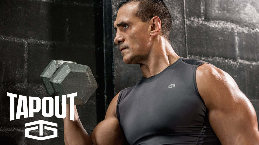 WWE Alberto Del Rio focused lifting dumbbell wearing Tapout shirt powerful gym workout background Wallpaper