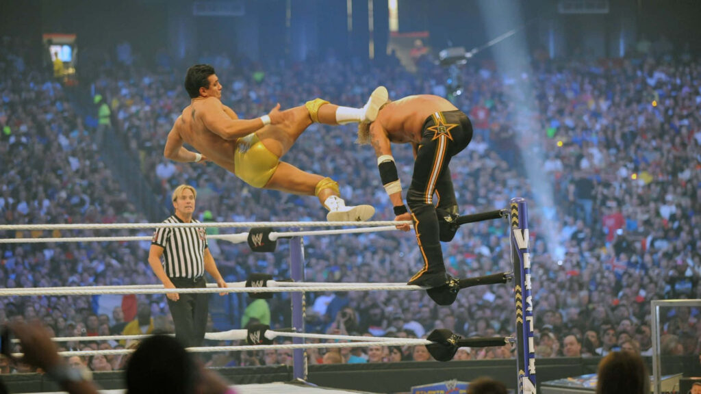 Alberto Del Rio performing a high-flying mid-air kick in an intense WWE wrestling match Wallpaper