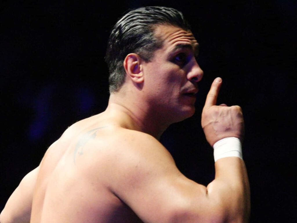 WWE superstar Alberto Del Rio in a silent pose with finger to lips striking wallpaper background